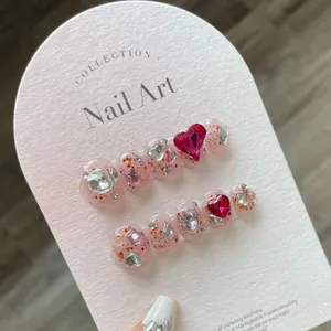 Short raspberry pink press-on nails with 3D heart gems and silver star glitter