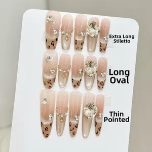 Detailed views of leopard print press-on nails in long coffin, oval, and stiletto shapes