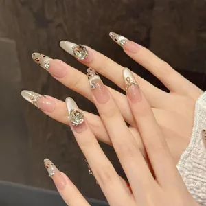 Detailed view of almond press-on nails with leopard patterns and 3D crystal crown accents