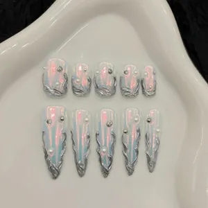 Macro view of Aurora metallic press-on nails with silver liquid chrome and pearl accents
