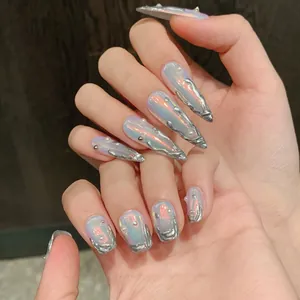 Detailed view of silver liquid metal texture and pearls on iridescent press-on nails