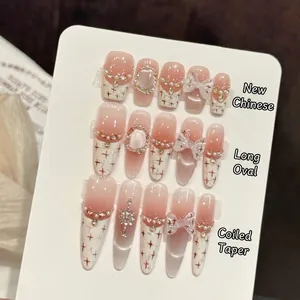 Handmade creamy white press-on nails with pearls, crystals, and 3D bowknot accents