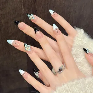 Detailed view of handmade almond press-on nails with 3D floral accents and French tips