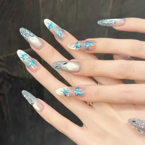 Blue butterfly gradient press-on nails with almond shape, pearls, and cat-eye finish