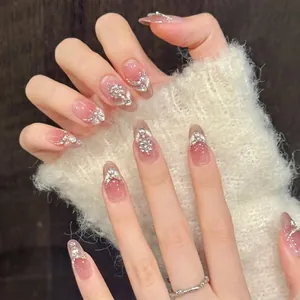 Peach cat eye press-on nails with luxury rhinestones and pearl accents in long almond shape