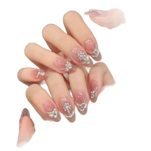 Elegant peach cat-eye press-on nails with silver rhinestones and pearl accents