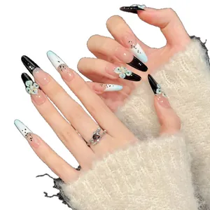 Black French almond press-on nails with blue relief flowers and glitter accents