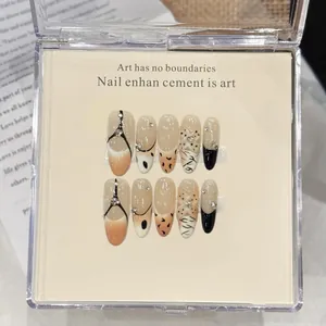 Detail of handmade leopard print press-on nails with 3D floral carving and rhinestones