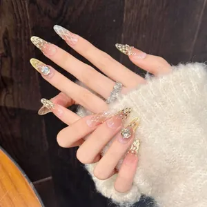 Close-up of handmade almond press-on nails with luxury diamond and pearl accents