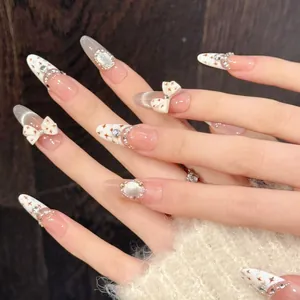 Detail of handmade French press-on nails with cat-eye luster and 3D pearl bow accents