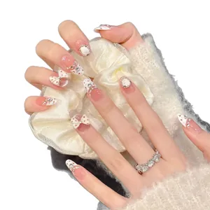 Pink gradient press-on nails with 3D white bows, rhinestones and star patterns