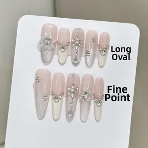 Detail of pink gradient press-on nails with 3D white flowers, pearls and rhinestones
