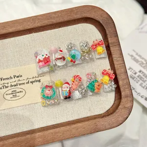 Detail of handmade Christmas press-on nails featuring 3D Santa, snowman, and festive motifs