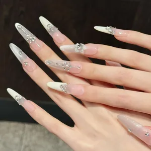 Detail of pink gradient press-on nails with 3D floral pearls and crystal embellishments