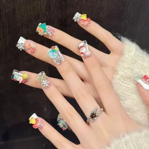 Detailed view of handmade Christmas press-on nails with 3D Santa and reindeer charms
