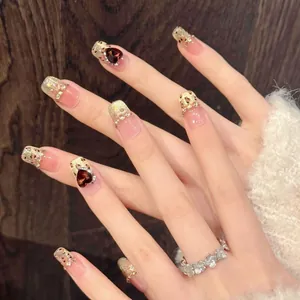 Detail of handmade cat-eye press-on nails with sunset leopard print and glitter