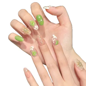 Floral press-on nails with 3D blossoms, pearls, and green hand-painted patterns