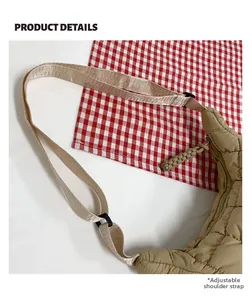 Detail view of khaki quilted crossbody bag with adjustable strap and braided zipper