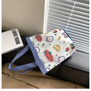 Detailed shot of a cute cartoon canvas bucket bag with rabbit and strawberry prints