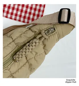 Close-up of quilted beige crossbody bag featuring an exquisite braided zipper pull