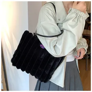 Detail of black faux fur tote bag with vertical stripes and fashion girl patch