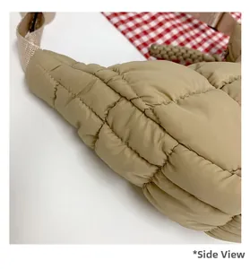 Detail showing square quilted texture and side stitching of the beige cloud puff bag