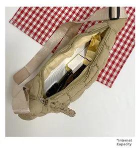 Detail view of khaki cloud pleated bag showing large internal capacity with essentials