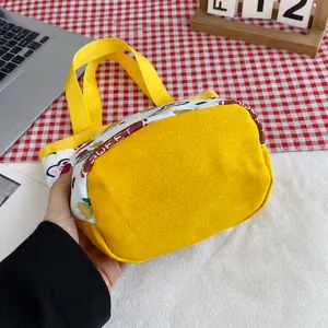 Close-up showing the durable canvas base of this yellow sweet printed bucket bag