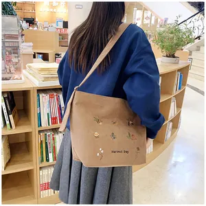 Brown corduroy tote bag with Harvest Day embroidery showing spacious student styling