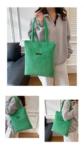Dettaglio della borsa tote in velluto a coste verdi con texture e toppa logo Fashion