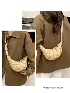 Beige quilted crescent crossbody bag shown on a 165cm model for size reference