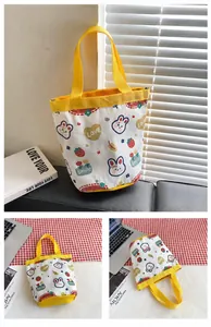 Detail view of yellow canvas bucket bag showing cute bunny and heart patterns