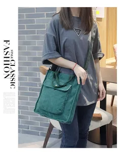 Deep green corduroy shoulder bag with adjustable strap shown on female model