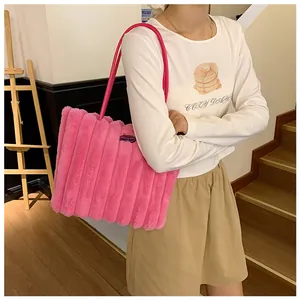 Pink plush tote bag featuring faux fur vertical stripes and long leather straps