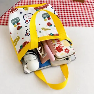 Detail showing internal storage capacity of the canvas tote bag with yellow handles