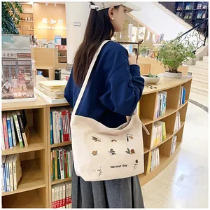 Detailed embroidery of harvest day motif on beige corduroy tote bag surface