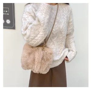 Détail du sac bandoulière en fausse fourrure beige avec une bandoulière tissée
