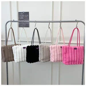Detailed row of plush tote bags in six colors hanging on a minimal metal rack