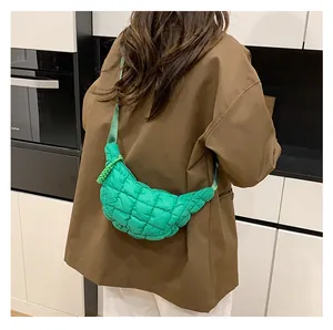 Close-up of bright green quilted dumpling bag with woven zipper and puffer texture