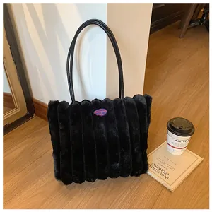 Detail view of black faux fur tote bag featuring fashion girl pink logo label