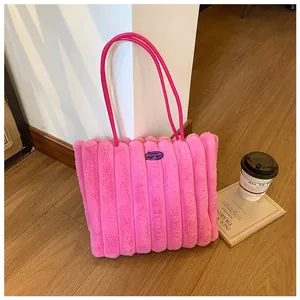 Detail of rose pink faux fur tote bag with quilted texture and fashion girl logo