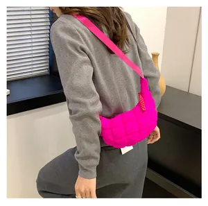 Detail of rose pink quilted cloud bag featuring soft padded texture and crossbody strap