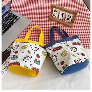 Detail of cute canvas bucket bags with cartoon bunny prints and colorful handles