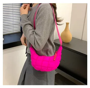 Detailed view of quilted hot pink cloud bag with puffed texture and wide shoulder strap