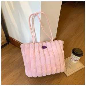 Detail of pink plush tote bag showing vertical quilted fur and cherry patch