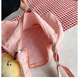 Detailed close-up showing inner space and zipper of pink waffle-textured tote bag