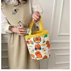 Détail des poignées jaunes sur un sac seau en toile avec imprimé tigre mignon