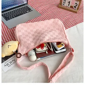 Pink waffle texture hobo bag showing large capacity with phone, umbrella and notebook