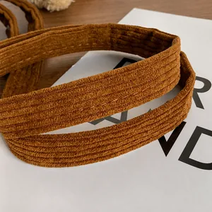 Detailed macro view of comfortable brown corduroy shoulder straps with reinforced stitching