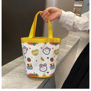 Cute cartoon canvas bucket bag with yellow handles for casual shopping or lunch carry
